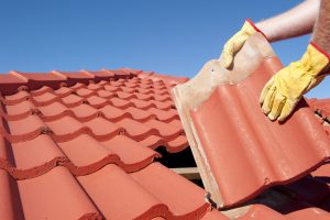 Construction worker tile roofing repair house